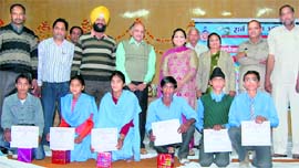 Deputy commissioner Amneet P. Kumar, ADC Ramesh Verma and DEO Kamla Midha honour meritorious students during a function held under the Sarv Shiksha Abhiyan in Kaithal recently