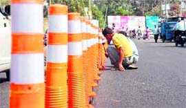 Bollards (road dividers) being installed on a road in Jammu on Thursday.