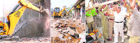 Illegal structures being pulled down near Dandi Swami market and old DMCH; and a shopkeeper opposes the anti-encroachment drive near Dandi Swami temple on Thursday.