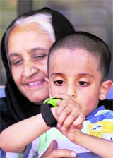 British child Sahil Saeed sits with his grandmother Tasneem Bashir at the British High Commission in Islamabad on Thursday.
