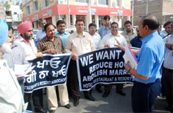 Members of the Hotel, Restaurant & Resort Association, protest in front of the BMC office demanding reduction in house tax, in Bathinda