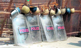 Protection gear of policemen lie at a barricade near the state Assembly House in Dehradun on Friday.