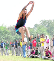 A player participates in the long jump competition at the annual sports meet of the FRI in Dehradun on Friday.