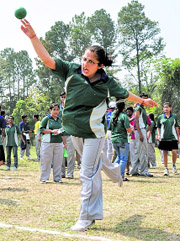 A girl puts a shot in the shot put event.