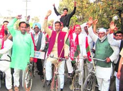 Samajwadi Party workers take out a cycle rally in Dehradun on Friday. 