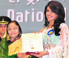 Priyanka Chopra receives the award for Best Actress from President Pratibha Patil in New Delhi on Friday.