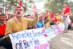 Activists of the CPM raise slogans against hike in bus fares at Shimla on Saturday. A Tribune photo