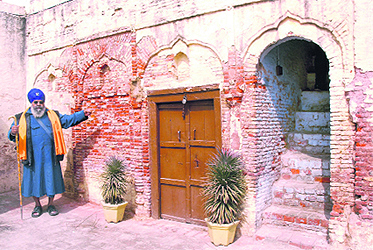 A villager shows a crumbling wall at the ancestral house of Shaheed Bhagat Singh in Khatkar Kalan village, near Banga.