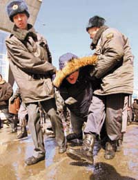 Police detains an opposition supporter during a rally to defend the ecology of Lake Baikal in Russias city of Irkutsk