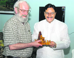 Uttarakhand Chief Minister Ramesh Pokhriyal Nishank presents a memento to Prof Paul R Bras of Washington University in Dehradun on Sunday. 