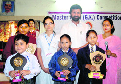 Winners of the Mastermind quiz with Uttarakhand Parliamentary Affairs Minister Prakash Pant in Dehradun on Sunday. 