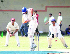 A batsman defends during a match at the 3rd All-India Uttarakhand Cup in Dehradun on Sunday