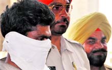 The murder accused in police custody in Ludhiana on Sunday. A Tribune photograph