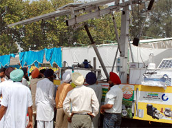 Farmers watch the functioning of solar water pump at the Kisan Mela in Bathinda on Monday.