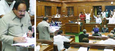 (Left) Delhi finance minister A.K. Walia delivers budget speech in Delhi Assembly on Monday. Opposition members disrupt the proceedings over price rise
