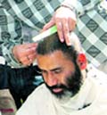 MS Mehta, gets his head tonsured in Dehradun on Monday. A Tribune photograph