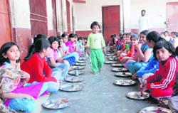 Children queue up for meals at MDD Bal Bhavan, an orphanage, in Phoosgarh village, Karnal.
