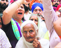 Riot victims protest at the mini secretariat in Ludhiana on Monday.