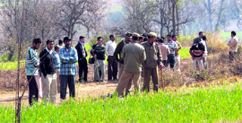 Scared villagers and policemen on the lookout for a leopard, which sneaked into Loharda village, near Hamirpur, recently.