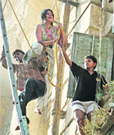 Firefighters rescue a woman from the building in Kolkata on Tuesday.