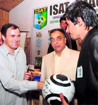 Chief Minister Omar Abdullah gives a football bearing his signature to a local player, Hanan, at a function in Srinagar on Tuesday. Hanan is one of the two Kashmir youths selected for one-year training in Brazil. 