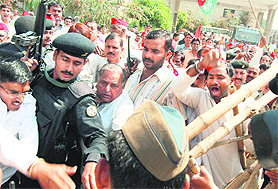Samajwadi Party chief Mulayam Singh Yadav has an altercation with police personnel before unveiling a statue of Ram Manohar Lohia at RML Hospital, Gomti Nagar, Lucknow, on Tuesday.