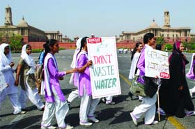 Schoolchildren and their teachers march in front of the Rajpath during a 'Save Water' campaign in New Delhi