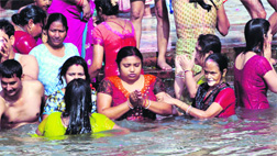 Women offer water to Sun God in Haridwar on Wednesday.