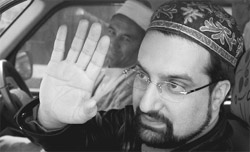 The Hurriet Conference chairman, Mirwaiz Umar Farooq, waves to his supporters on return from Geneva. 
