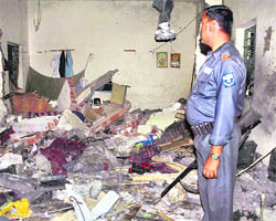 A security personnel inspects the damaged toll plaza after it was blown up by Maoists in Gaya, Bihar, on Wednesday.