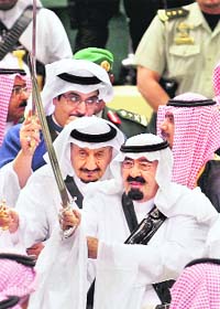 King Abdullah (right) of Saudi Arabia holds sword as he takes part in the traditional Arda dance, or War dance, during the Janadriyah Festival of Heritage and Culture on the outskirts of Riyadh