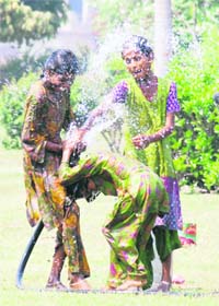 GIRLS JUST WANNA HAVE FUN: With the temperature rising above normal, these girls dont mind playing with water at a park in Karnal