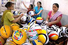 Workers in a factory pack footballs to address the craze before the FIFA World Cup. 