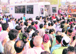 People gather at the scene of the accident in Ludhiana on Thursday.