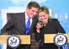 Pakistan Foreign Minister Shah Mehmood Qureshi shares a light moment with US Secretary of State Hillary Clinton in Washington