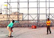 Serious Safety issues: Iron grills being fitted to put up a new hoarding at the terrace of Nehru Shopping Complex building in Amritsar.