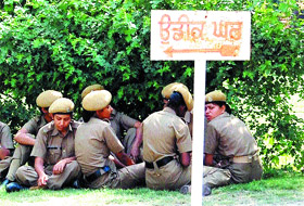 Lady police constables take rest outside a rest house in Amritsar. 