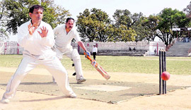A bowler tries for run out the batsman during a match in the Central Government Employees Welfare Coordination Committee Cricket Tournament being held in Dehradun on Friday.