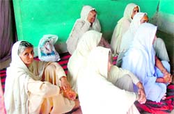 Relatives mourn the death of Dhano Devi, who was allegedly killed by her son at Sure Chak village on Friday. Tribune photo: Anand Sharma