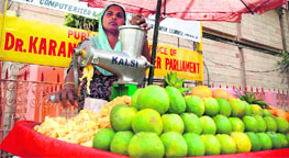 Suma Devi sells fruit juice in front of Gulab Bhawan in Jammu.
