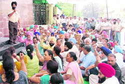 BSNL workers sit on a dharna in front of their general managers office in Ludhiana on Friday.