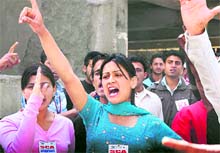 Activists of the SFI raise slogans in support of their demands in front of the vice-chancellors office at Shimla on Saturday. Tribune photo: Amit Kanwar