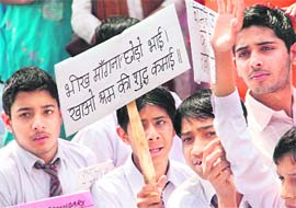 Members of the Vichar Kranti Manch International holds a protest against corruption outside the Governors house in Jammu on Saturday.
