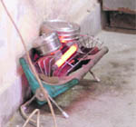 Lunch boxes kept on a room heater to warm food at the Ludhiana Improvement Trust office.