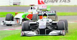 Mercedes driver Nico Rosberg (R) spears off the track in front of Force Indias Adrain Sutil during the qualifying for Formula One's Australian Grand Prix, in Melbourne on on Saturday. Sebastian Vettel took pole position for Sundays race. 
