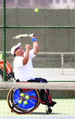 Wheelchair tennis champion Harish Bist serves during the AITA Ranking Wheelchair Tennis tournament in Mumbai