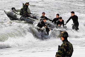 South Korean Navys rescue members search for possible survivors from sunken naval ship Cheonan at the seashore on Baengnyeongdo, an island near the border with N. Korea