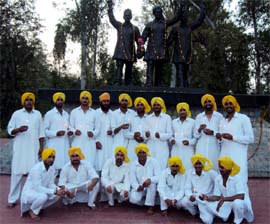 Youths with lighted candles in front of the statues of Shaheed Bhagat Singh, Rajguru and Sukhdev at Hussainiwala on Martyrs Day recently. A Tribune photograph