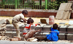 Children of the workers at a project site of the Commonwealth Games at Tolstoy Marg in New Delhi on Sunday