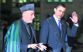 US President Barack Obama with his Afghan counterpart Hamid Karzai in Kabul on Sunday. 